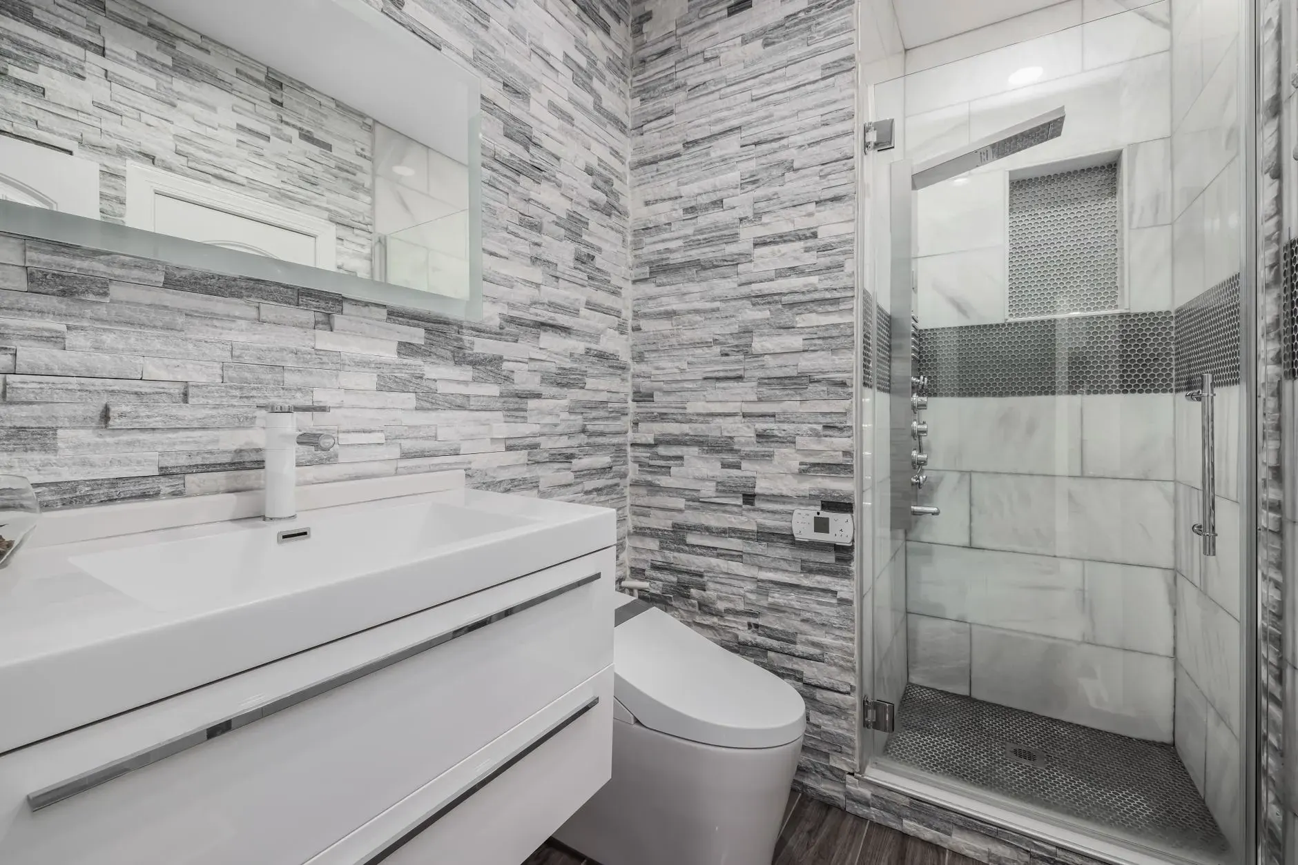 Modern bathroom remodel in Fort Myers with tiled shower and glass enclosure