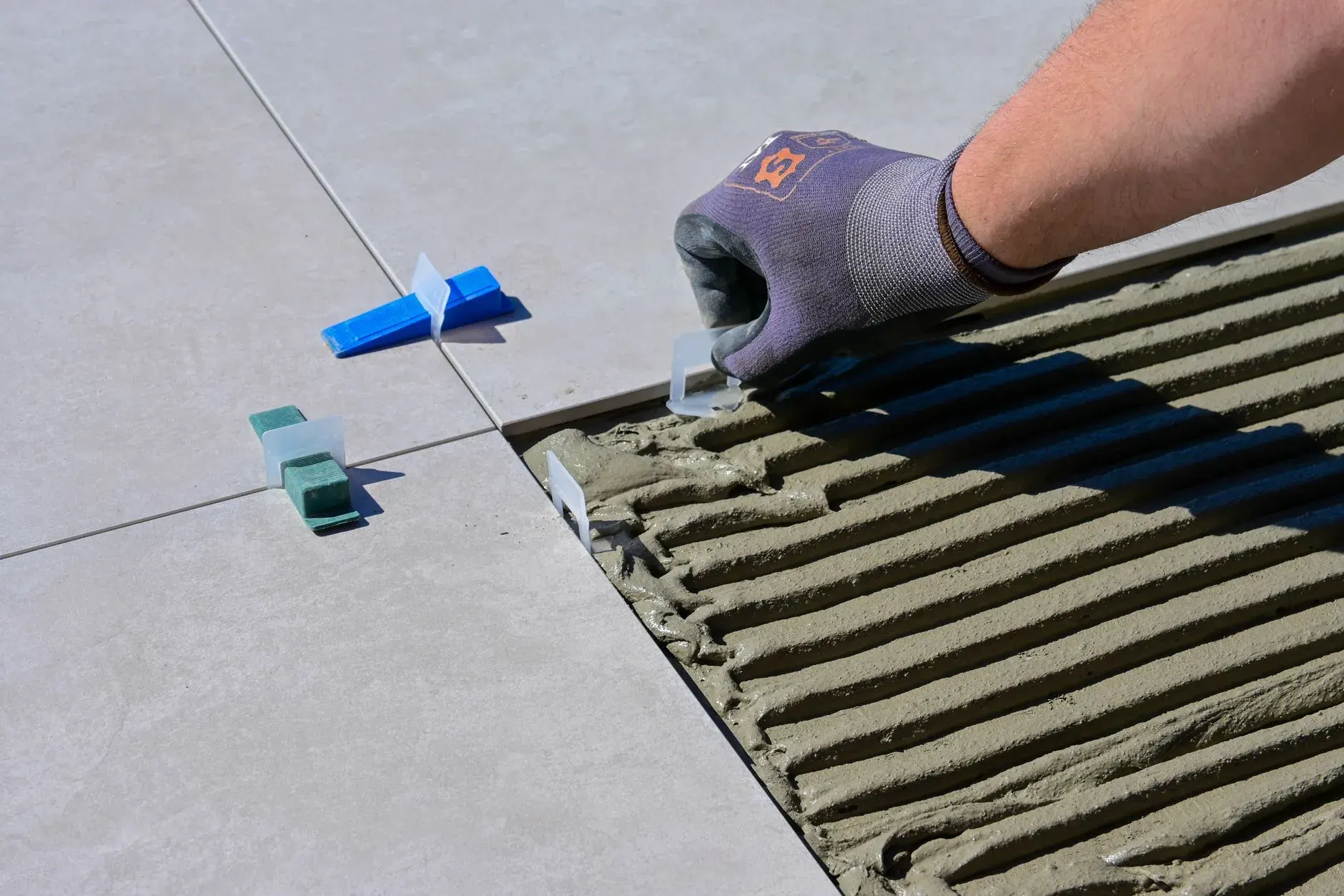 Large-format floor tile with spacers during flooring installation in Lehigh Acres