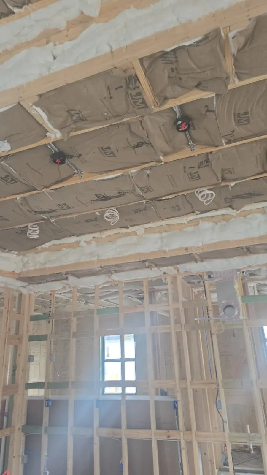 Framing and insulation exposed before drywall goes up in a Lehigh Acres remodel